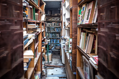 racks with books in old abandoned library