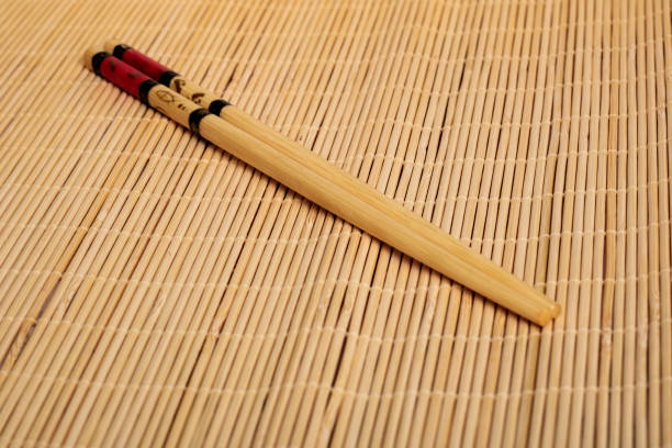 istock Chinese chopsticks on a straw napkin close up 1298707853