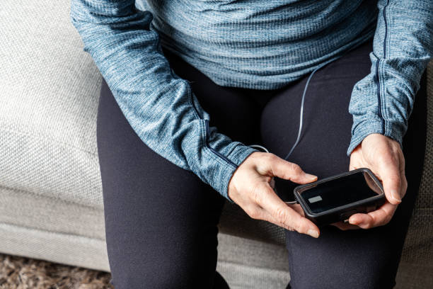 Woman Using Insulin Pump stock photo