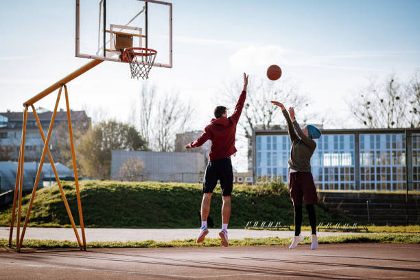 istock People playing basketball outdoors after lockdown 1298708027