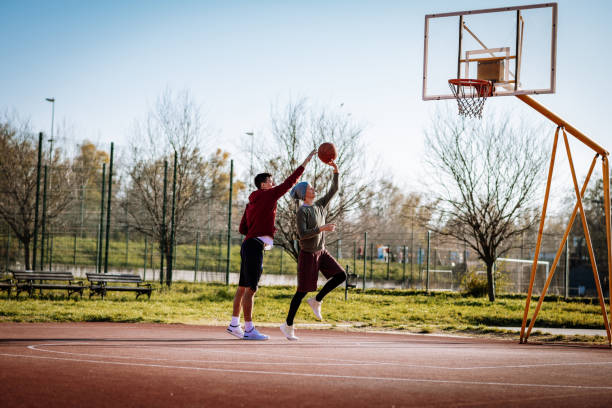 istock Confident woman playing basketball with her partner 1298708205