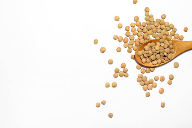 istock lentils in wood spoon on white background 1298709198