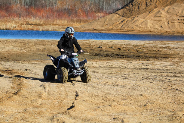 istock A young boy driving his atv in a sand quarry 1298712767
