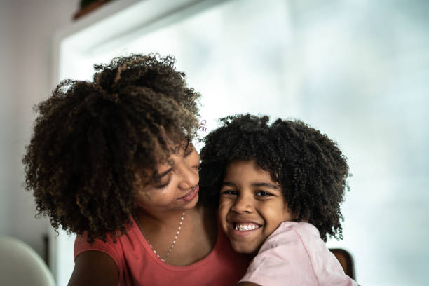 istock Mother and son embracing at home 1298714642