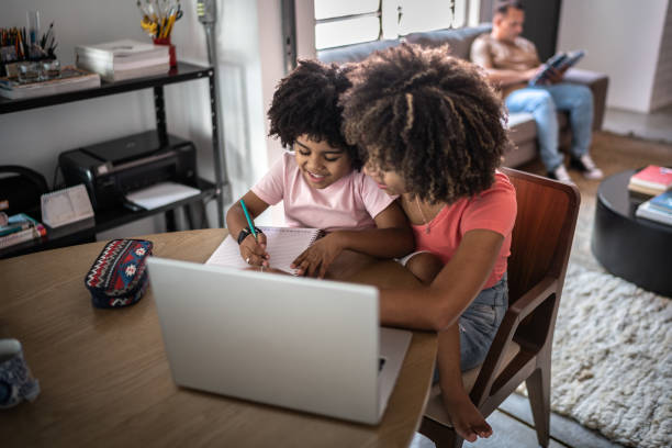 istock Mother helping son during homeschooling 1298714781