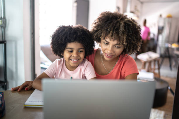 istock Mother helping son during homeschooling 1298714787