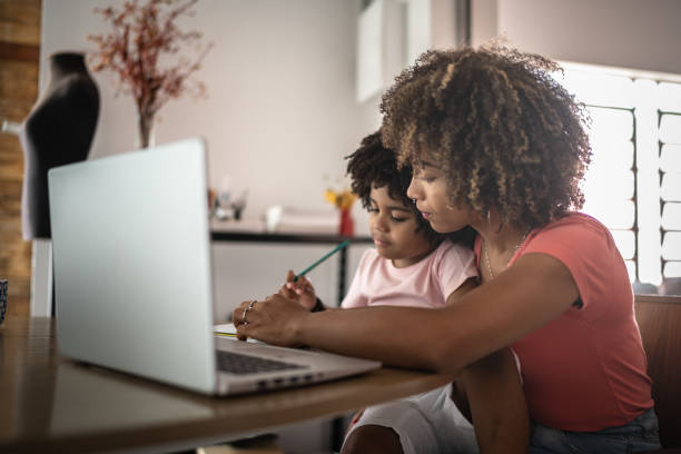 istock Mother helping son during homeschooling 1298714894