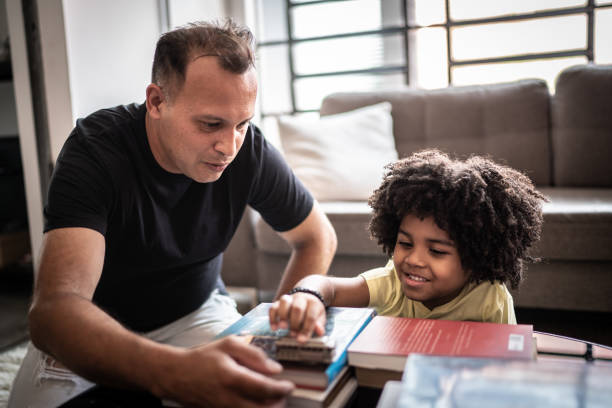 istock Father and son playing with toy car at home 1298715101