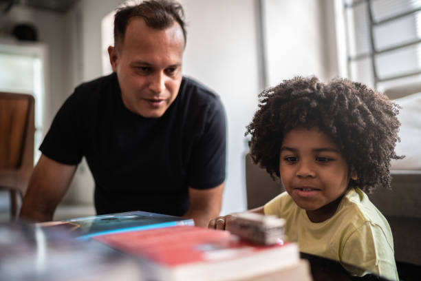 istock Father and son playing with toy car at home 1298715103