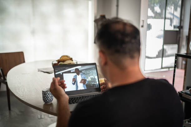 istock Man on a business video call at home 1298715193