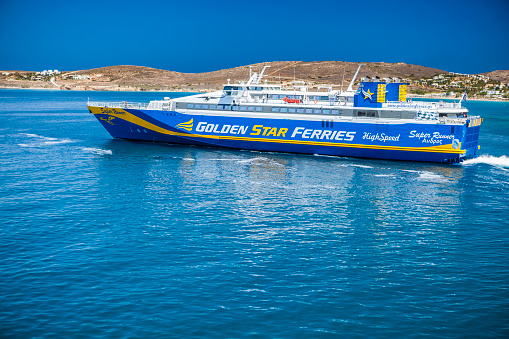 Paros island, Greece - July 03, 2018: View of part of Paros island in the Agean Sea, Greece. You can see in front of the island, the Super Runner ferry. The Super Runner is a fast ferry owned and operated by Golden Star Ferries.