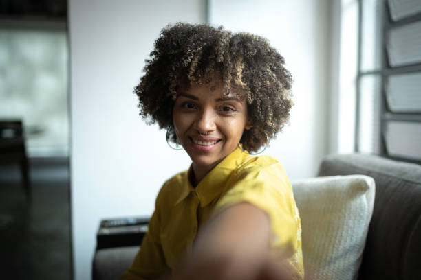 istock Young woman taking a selfie at home 1298715589