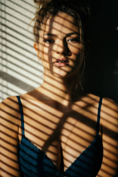 istock Beautiful young woman posing under the sunlight 1298717378