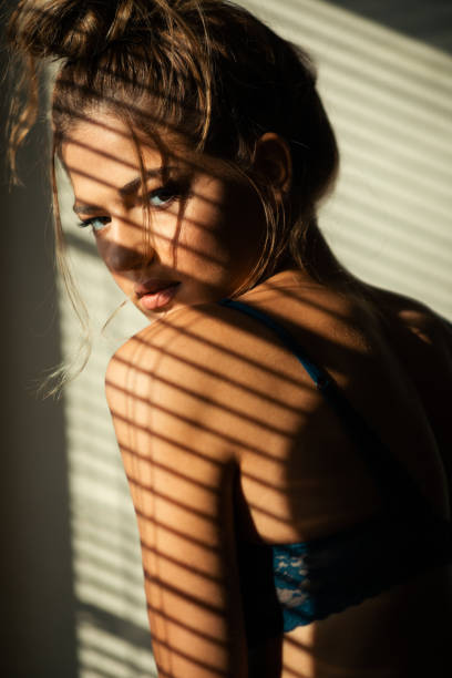 istock Beautiful young woman posing under the sunlight 1298717389