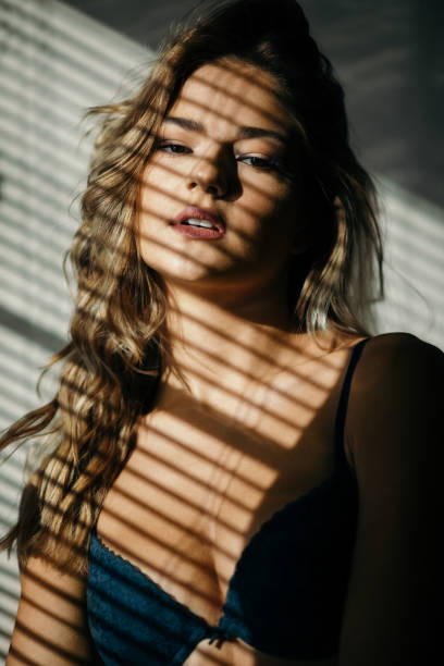 istock Beautiful young woman posing under the sunlight 1298717427