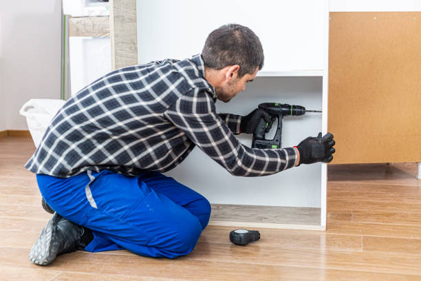 istock A carpenter drilling holes in a kitchen shelf 1298727369