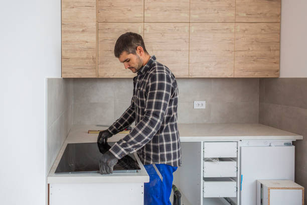 istock The carpenter sets up the induction hob in new kitchen 1298730574