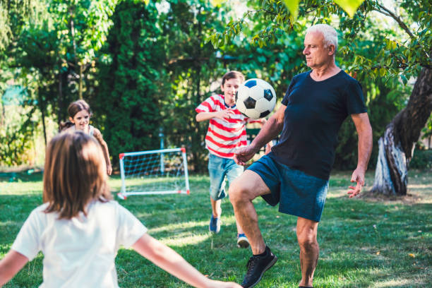 istock Family playing soccer in the back yard. 1298732607