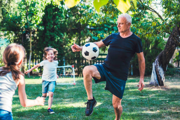 istock Family playing soccer in the back yard. 1298732614
