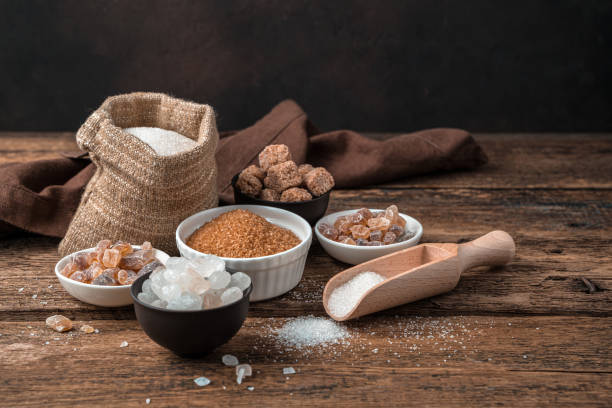 istock White and cane sugar on a wooden background. Side view with copy space 1298732896