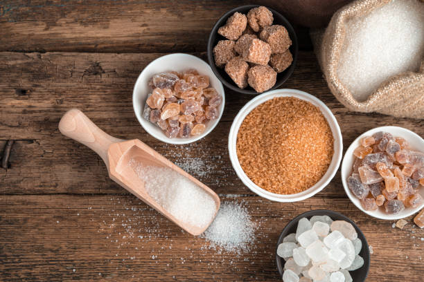 istock Cane, refined, crystalline sugar on a wooden background. Top view with copy space 1298733004