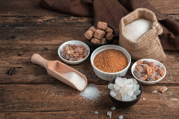 istock Sugar of different types on a wooden background. Side view with copy space 1298733753