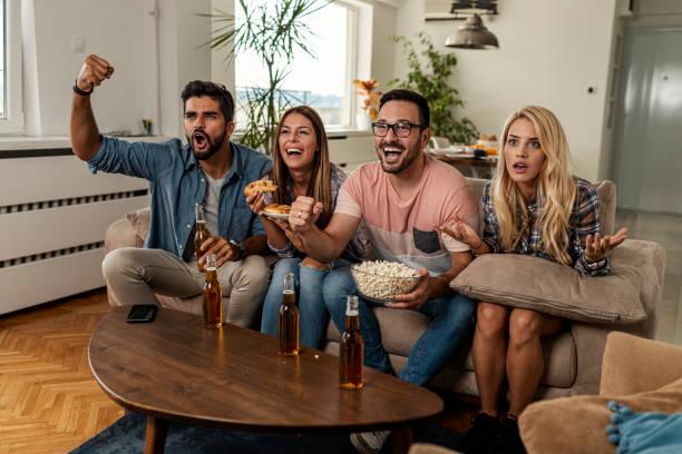 istock Friends watching sport on tv 1298733942