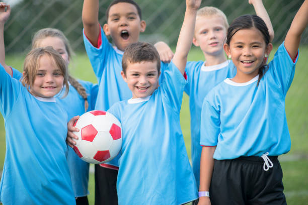 istock Happy children wearing soccer uniform 1298736053