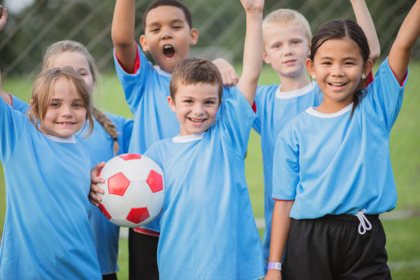 istock Happy children wearing soccer uniform 1298736059