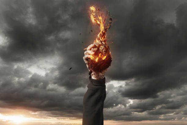 istock hand holding a tree on fire in the air. Concept climate change 1298736646