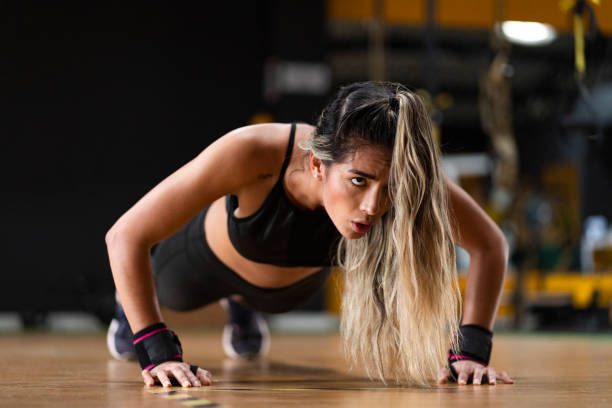 istock Latino ethnic woman exercising inside a gym 1298746518