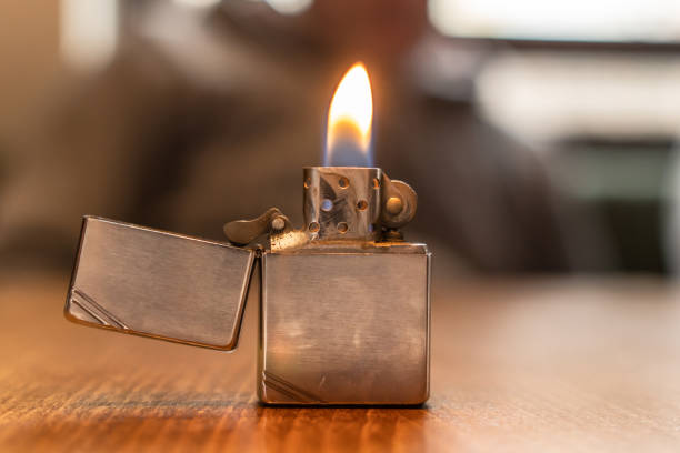 istock Front view on metal lighter on the table lighting fire in day 1298748530