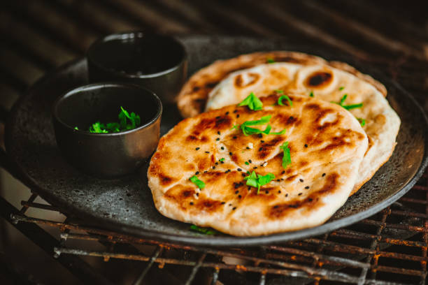 Traditional Indian Naan Flatbread Traditional Indian Garlic Naan Flatbread flatbread stock pictures, royalty-free photos & images