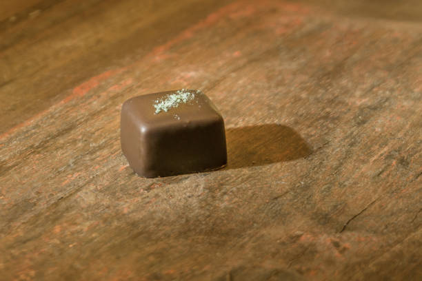 istock Dark chocolate mint praline on brown wooden table 1298749217