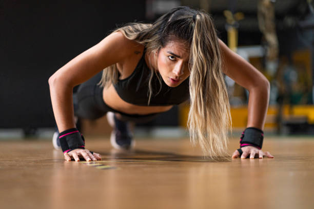 istock Latino ethnic woman exercising inside a gym 1298750331