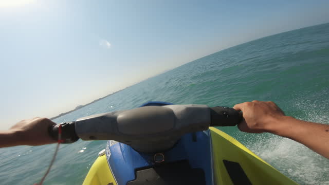 Young Couple on jet ski fast ride pov, Tropical Ocean, Vacation Concept