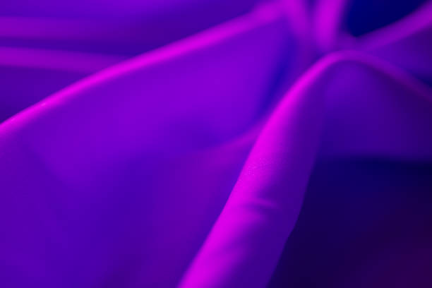 istock Luxurious satin purple silk or fabric. soft waves cloth abstract background. 1298762279