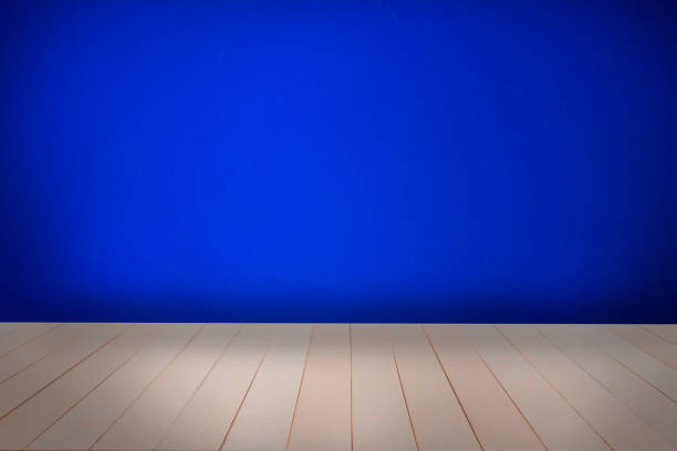 istock Empty room dark blue cement wall cover with floor old wood table. 1298763874