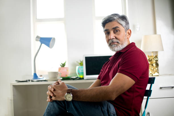istock Confident businessman sitting at office 1298766341