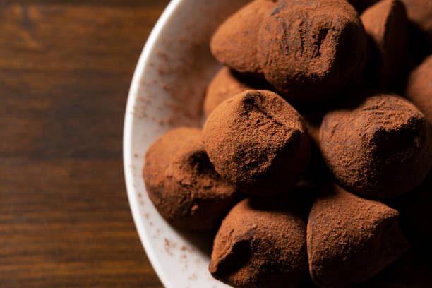 istock Chocolate truffles on a plate set against a wooden background 1298767537