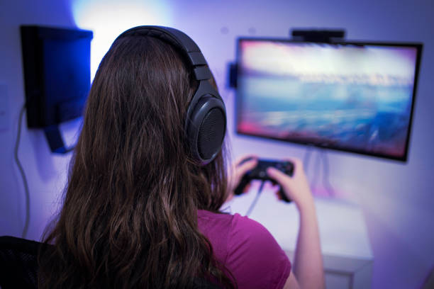 istock Young woman gamer playing video game 1298769529