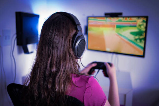 istock Young woman gamer playing video game 1298770022