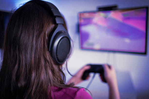 istock Young woman gamer playing video game 1298770653