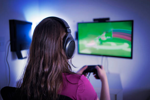 istock Young woman gamer playing video game 1298771017