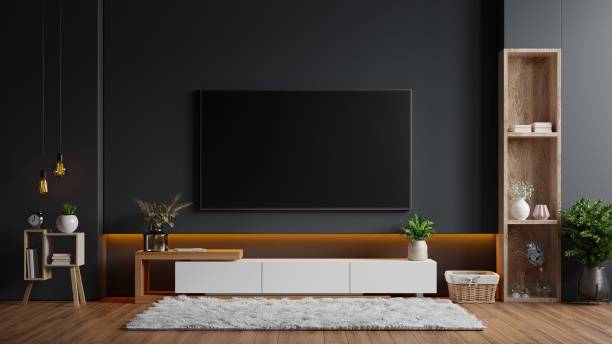 istock Mockup a TV wall mounted in a dark room with a black wall. 1298777061