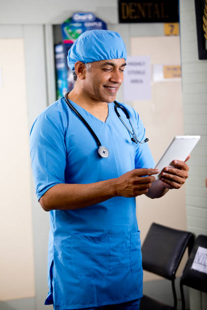 istock Male surgeon using digital tablet at hospital 1298779989