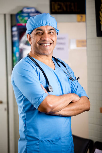 istock Happy male surgeon with arms crossed 1298780170
