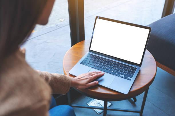 istock a woman using and touching on laptop touchpad with blank white desktop screen in cafe 1298780244