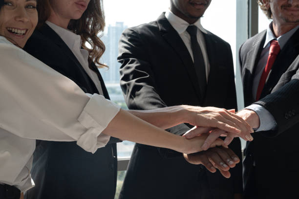 istock Group of diversity business people hands stack together at the office. 1298785021
