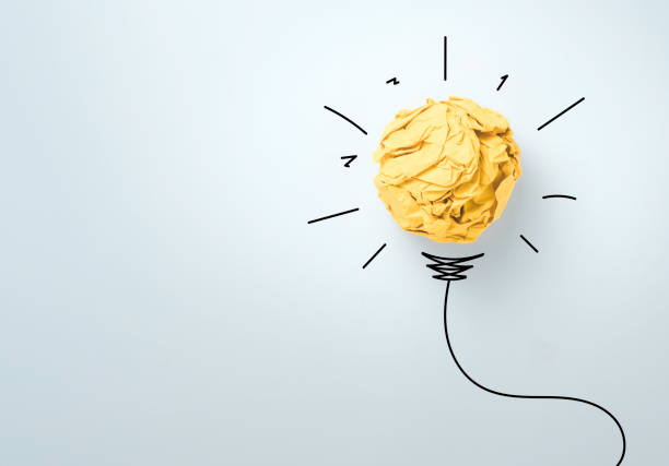 istock Yellow scrap paper ball with illustration painting for virtual lightbulb. It is creative thinking idea and innovation concept. 1298788633